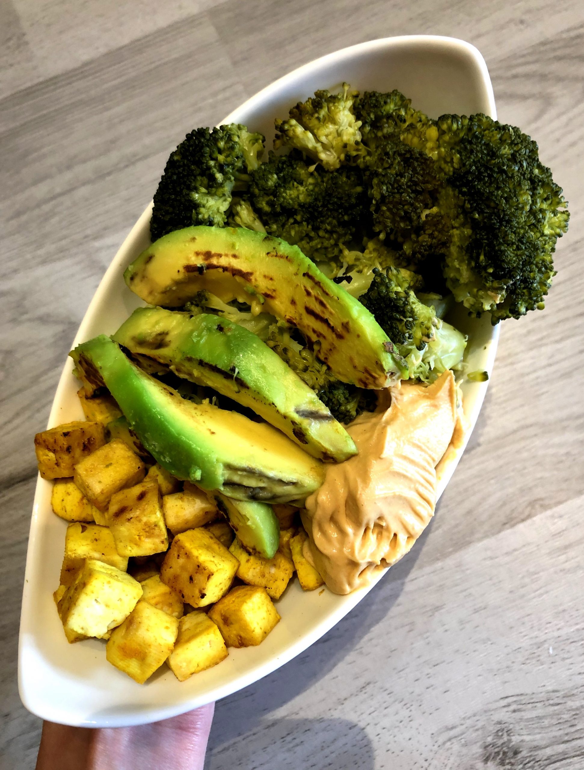 Vegan broccoli bowl with hummus and tofu